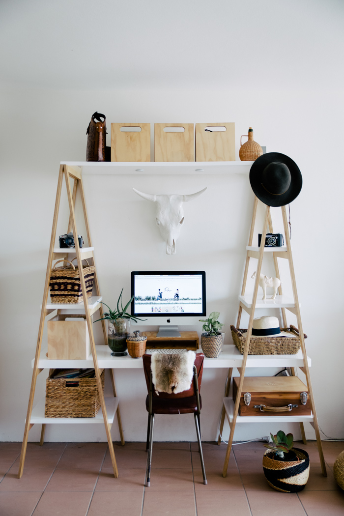 Office desk with white wall and racks